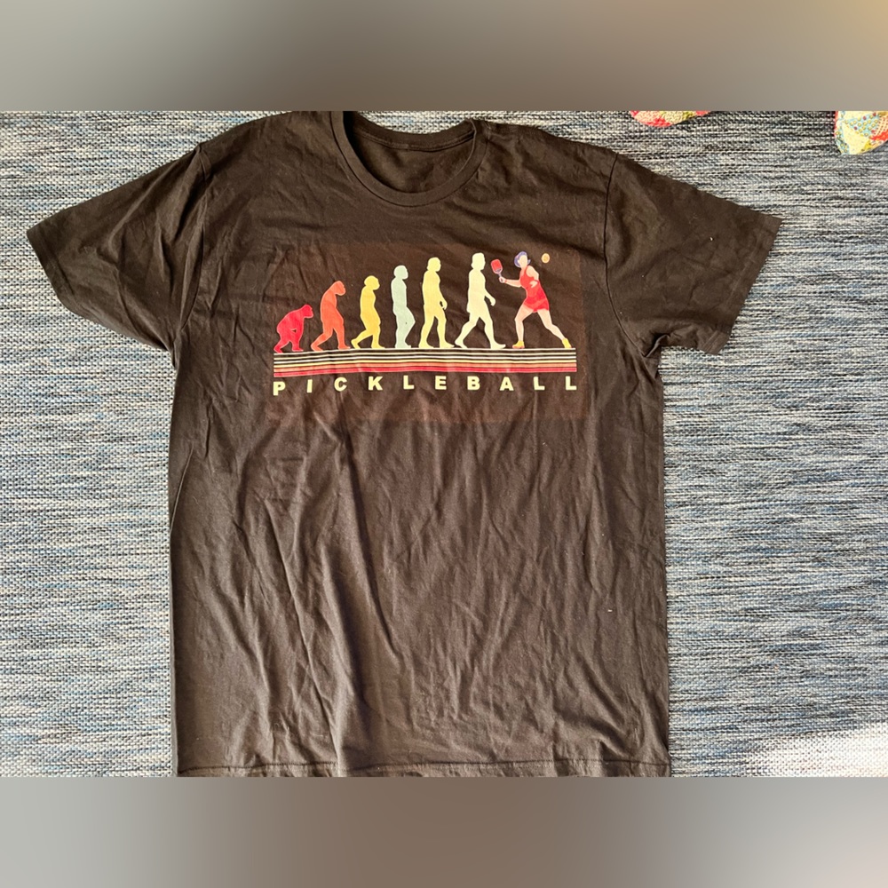 Size large pickle ball shirt.  Showing the transition of cave man to pickle ball